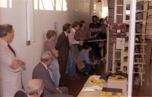 Photo:On transfer day, other engineers first disconnect the customers lines from the old exchange (not shown here). Upon command, these engineers then carefully pull the strings to remove the wedges that isolated the customers from the new exchange in a matter of seconds.
