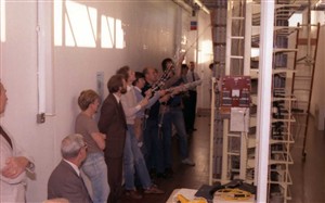 Photo:Many hands make light work. Engineering managers watch anxiously over the operation with crossed fingers!