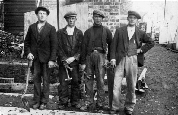 Photo:John Edward Delacourt, who was a carpenter, on the far right.  Who are the others?