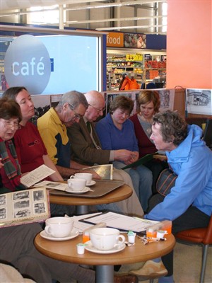 Photo:L-R: Mrs Balcombe, Joanna, Colin Holden, Peter Bailey, Sylvia, Jackie & Heather Holden share photos, memories and a coffee