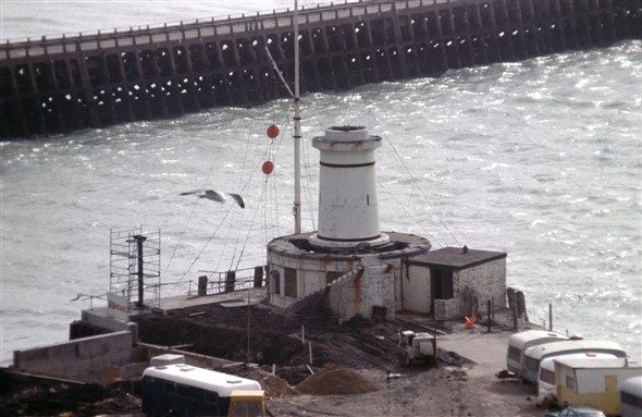 Photo:The concrete had been drilled way in the first picture for explosive charges to bring down the main structure. The signal pole is still doing its job of permitting ships entry to, or departure from the harbour.
