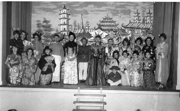 Photo:Aladdin - 1956.  Back row left to right - Doreen Molyneux, Vera Jeffrey, Yvonne Hadley, Richard Halpin, Susan Rayner, Christopher Coleman, Graham Amy, John Poulter?, Melody Rhona?, ?, Susan Farrow, Carol Page.  Front row left to right - Suzanne Black, Barbara Sturmey?, Brenda Delacourt, Sheila Scarth, Carol Eager, Susan Ingram, Linda Everest.  The boy in the front could be either Jim or Colin Page.