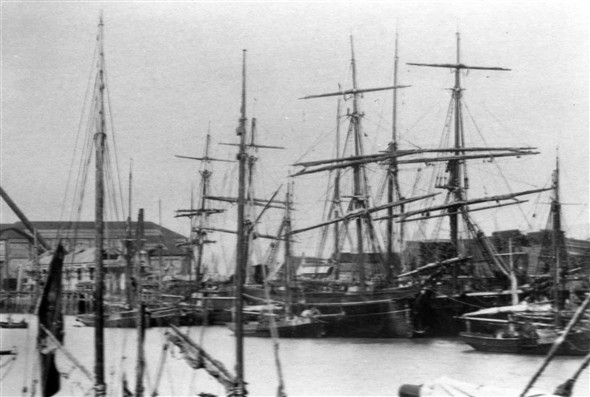 Photo:Putting the roof on the carpenters/paint workshop. The square rigger shown front right is the "Emily Smeed"owned by J Bull.
