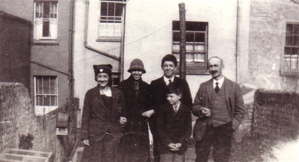 Photo:Photo taken at the rear of 39 Meeching Road c1927. L-R: Sister Myrtle (wearing her Convent Day School hat), Olive Archer (daughter of Freddy), brother Ray, me (Peter Bailey) and Dad. Note the meat safe on the left dividing wall and the glass top of the cold frame. This was carried by me (Peter) and neighbour Reg Hibling (who died recently in 2008) to 66 Hillcrest Road when we moved there. Reg's ball had come over wall earlier and broken a pane of glass hence him helping to carry it after repair!